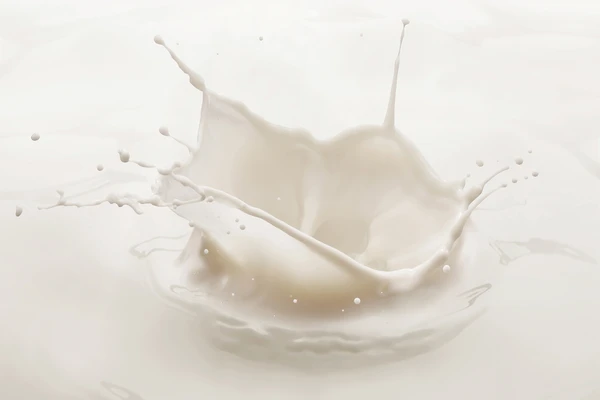 A drop of milk landing in a vat, causing a large splash