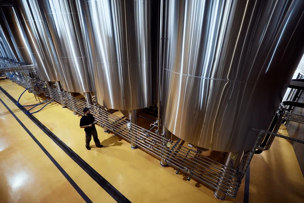 Fermentation tanks seen from above with worker below