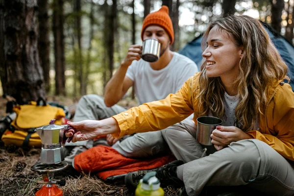 Girl_and_Boy_drinking_coffee_in_the_forest.jpg