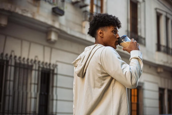 man drinking plantbased latte