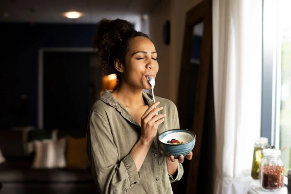 woman-enjoying-yoghurt-eyes-closed-novonesis