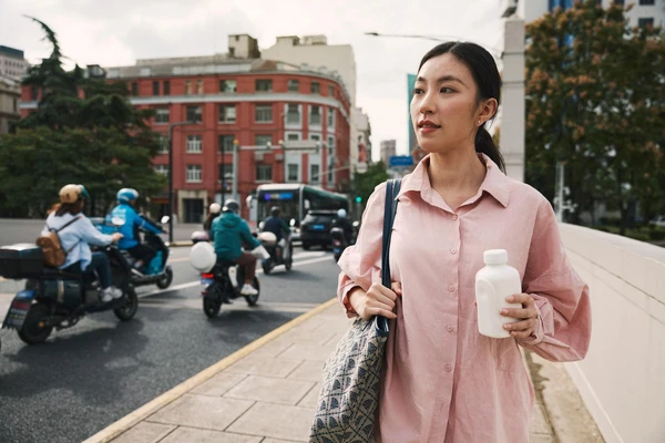 woman-walking-pathway-dairy-bottle-novonesis