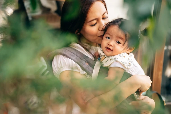 baby girl hugging mother