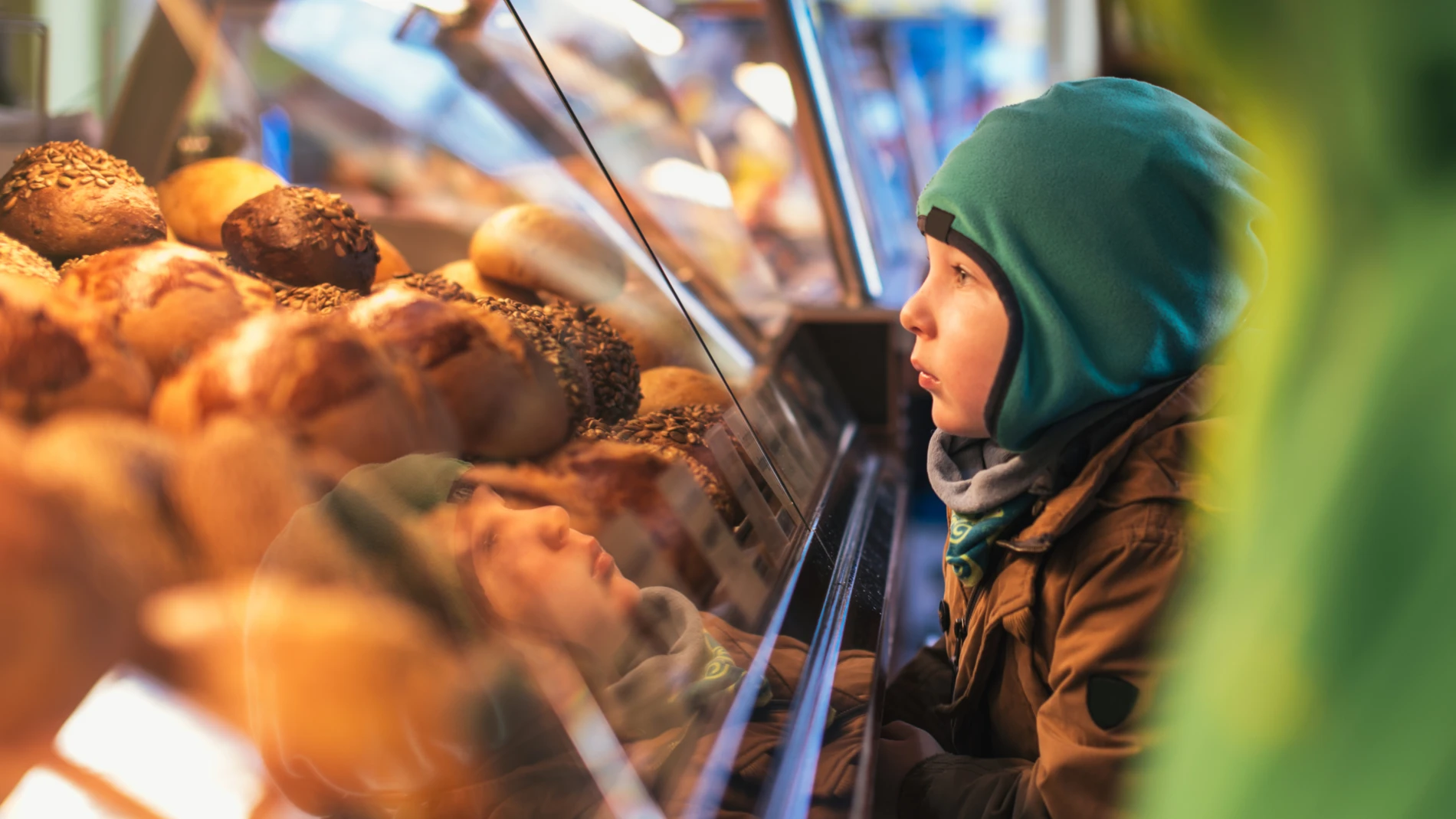 Kid looking at bread in an in-store bakery