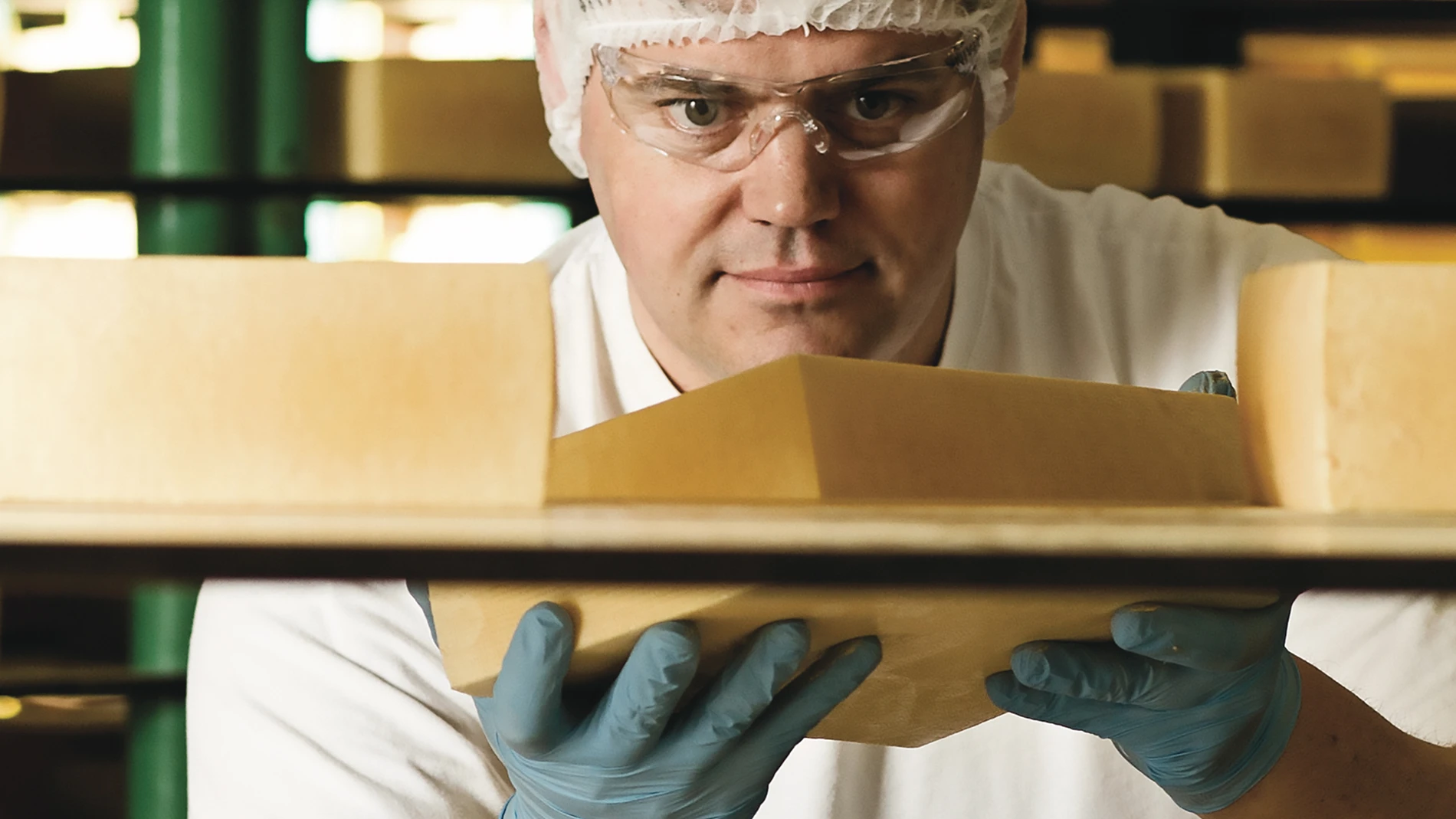 Cheesemaker holding cheese