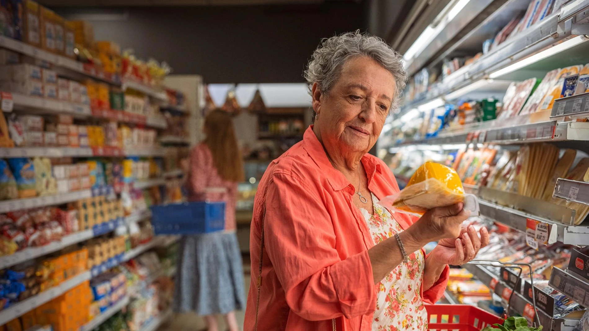 Woman looking at cheese supermarket