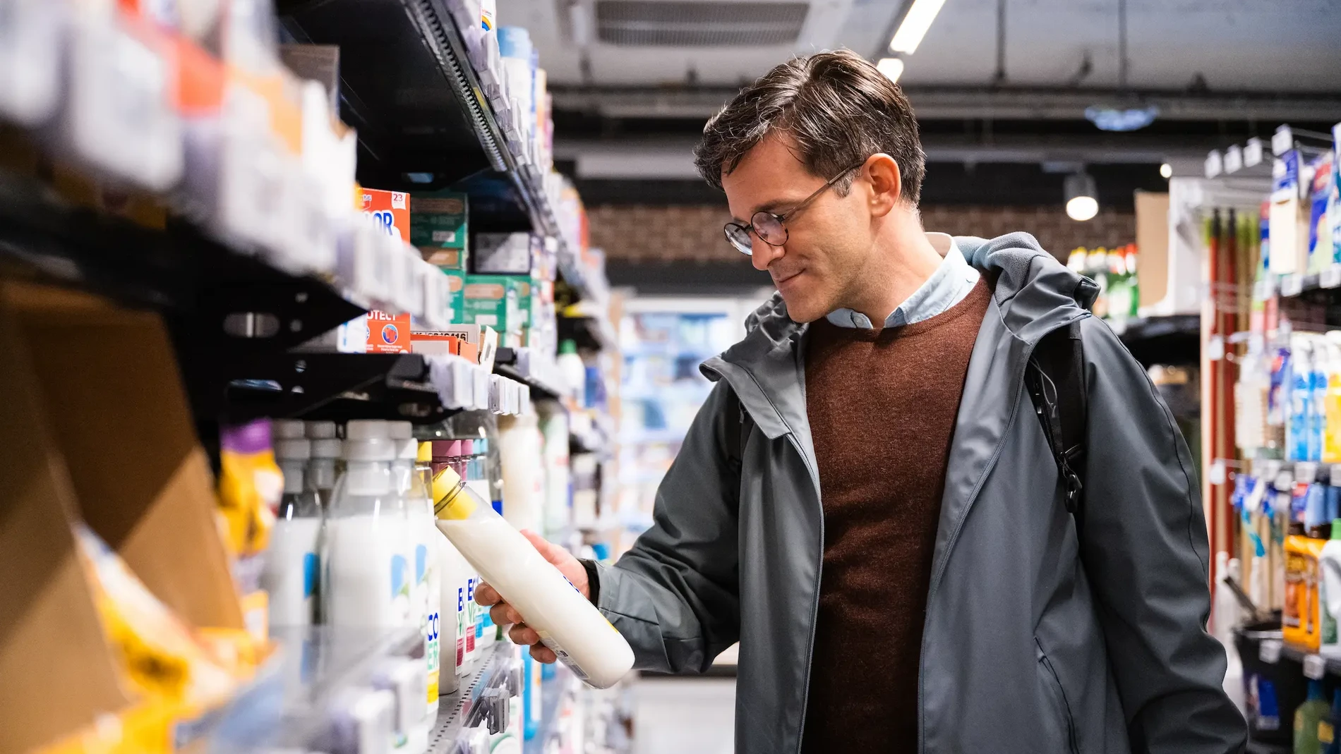 man buying fabric softener in the supermarket