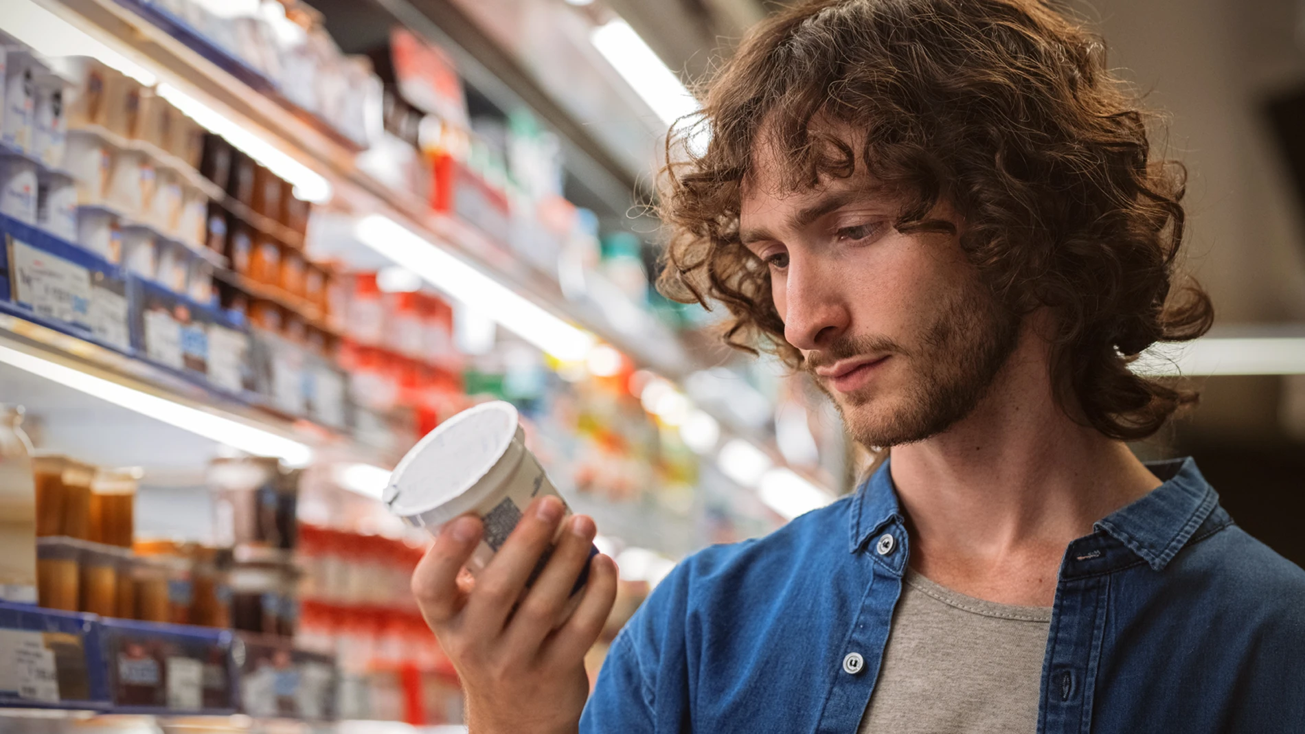 Man looking at fermented milk in a supermarket