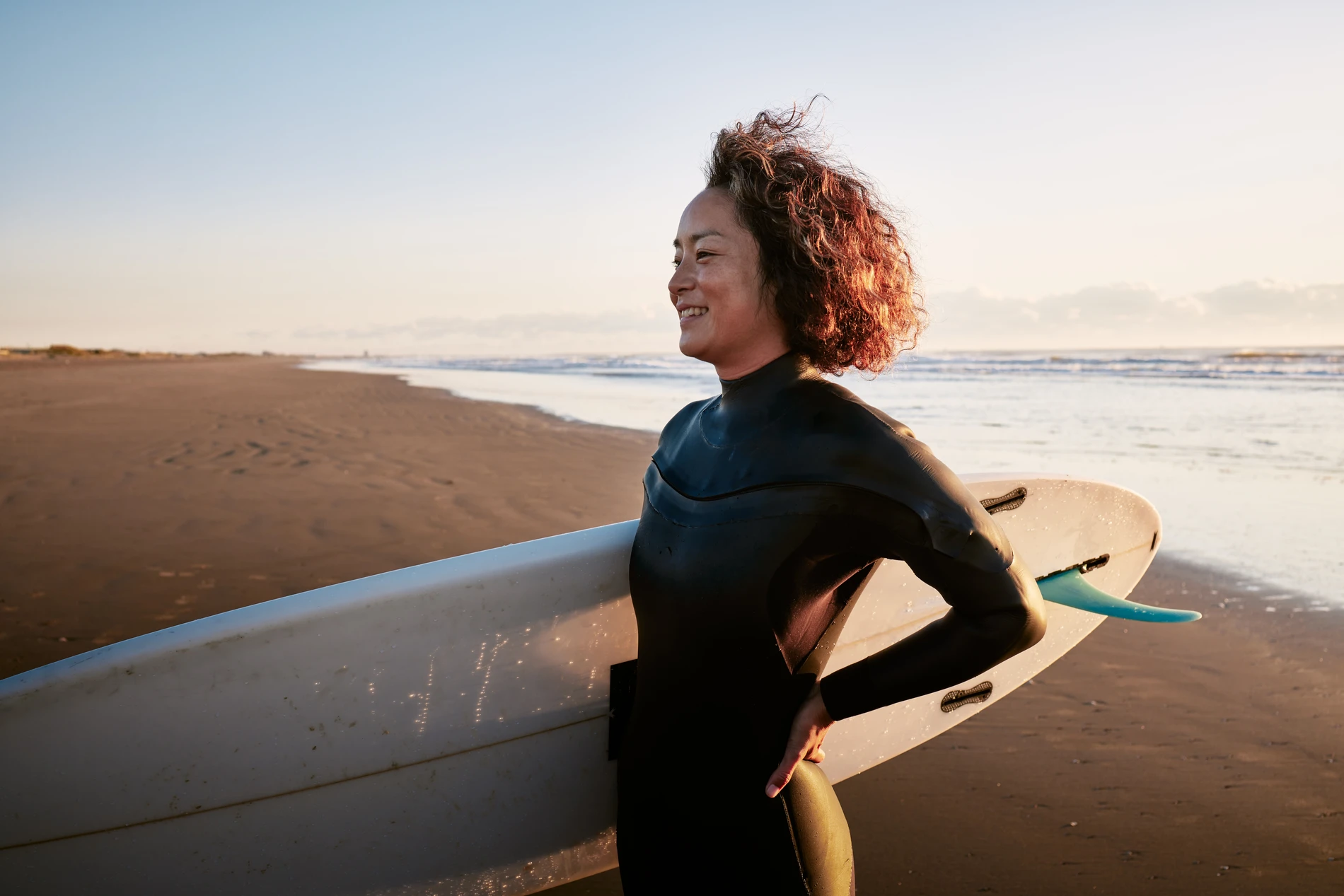 healthy person holding surfboard at the beach