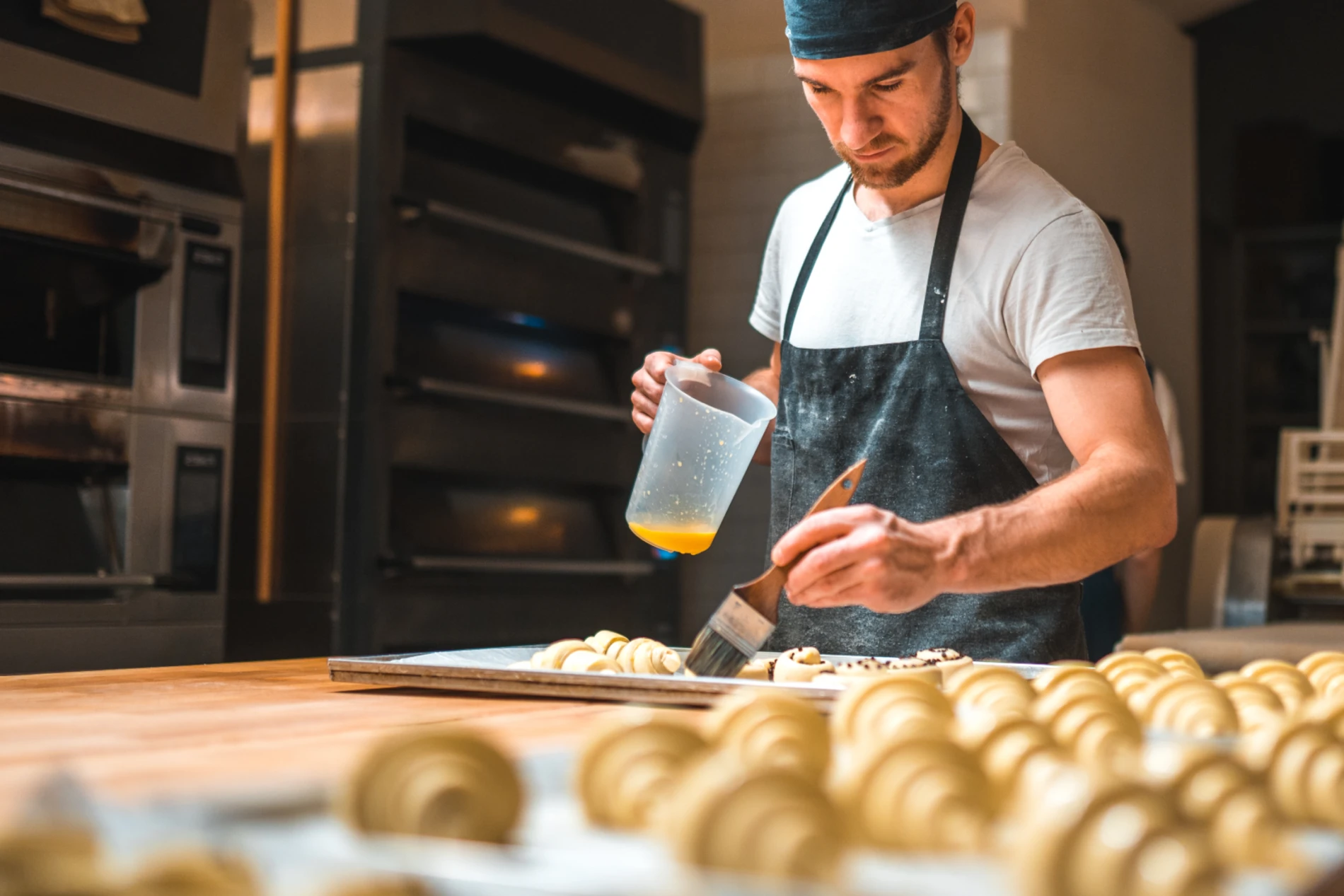 Man buttering croissants 